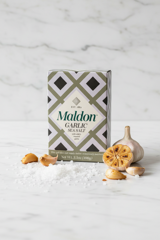 Maldon Garlic Sea Salt box packaging, featuring a geometric pattern of olive green, light purple, and black diamonds with a cream center label.