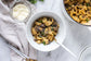 Bowls of pasta with mushrooms and herbs on a marble surface