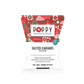 A bag of Poppy Hand-Crafted Popcorn in the Salted Caramel flavor, featuring a festive red and green holiday-themed header card on a white bag.